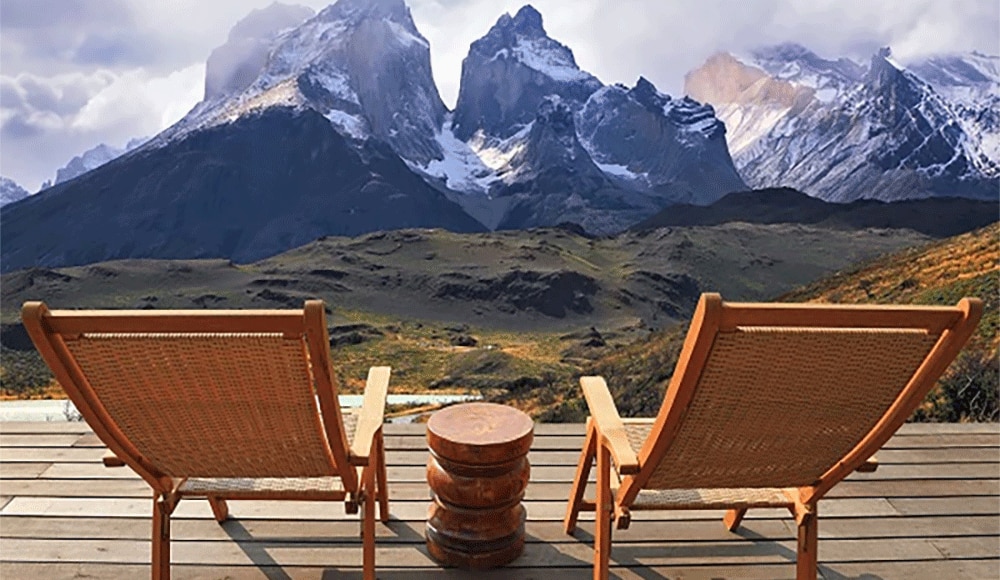 Two empty chairs facing the mountainscape